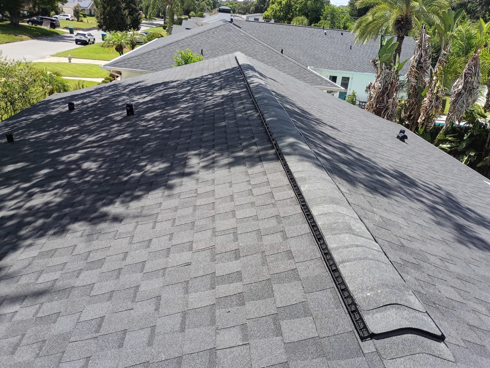 Gray shingle roof with ridge vent on residential home